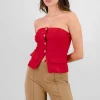 Top formal con bolsas y accentos de botones