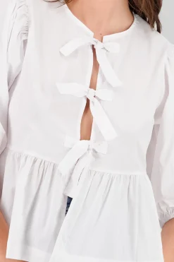 Blusa abullonada con moños lisa
