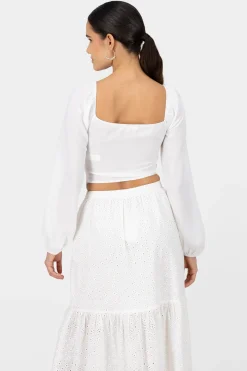 Top de manga larga con copas y detalle de rosa