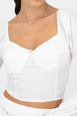 Top de manga larga con copas y detalle de rosa