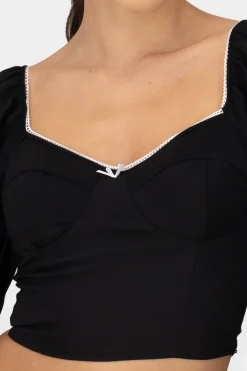 Top de manga larga con copas y detalle de moño